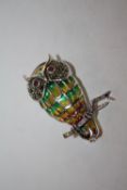 A STERLING SILVER PLIQUE DE JOUR BROOCH IN THE FORM OF AN OWL ON A BRANCH