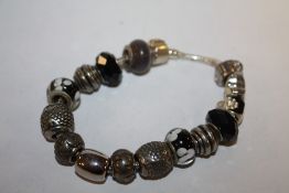 A SILVER CHARM BRACELET STAMPED 925- APPROX WEIGHT 32.7G