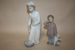 TWO NAO FIGURES OF A LADY BATHING FEET AND A BOY WITH A TEDDY BEAR A/F