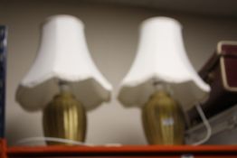 A PAIR OF GOLD TABLE LAMPS WITH SHADES