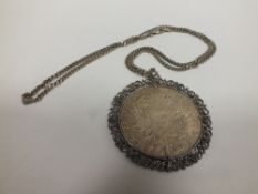 A COIN PENDANT ON SILVER CHAIN