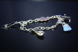 A MODERN STERLING SILVER CHARM BRACELET, TOTAL WEIGHT 10.3 G
