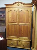 A HONEY PINE DOUBLE WARDROBE WITH 2 DRAWERS BELOW H 218 CM W 129 CM