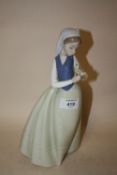 A NAO FIGURE OF A LADY HOLDING A BIRD