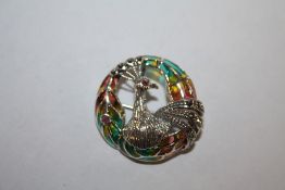 A STERLING SILVER PLIQUE DE JOUR BROOCH IN THE FORM OF A PEACOCK