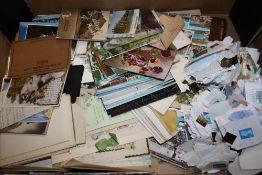 A TRAY OF VINTAGE POSTCARDS, STAMPS ETC.
