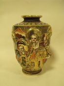 A JAPANESE CERAMIC FIGURAL VASE WITH ORNATE RELIEF
