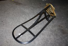 A BRASS AND CAST METAL HORSE SADDLE RACK TOGETHER WITH A BRASS STICK STAND