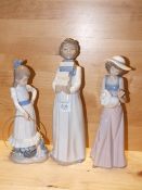THREE NAO FIGURES COMPRISING BOY CARRYING BOOKS, A GIRL WITH A HULA HOOP AND A GIRL WITH A DOLL, ALL
