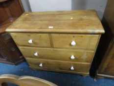 AN ANTIQUE SMALL PINE FOUR DRAWER CHEST ON BUN FEET H-86 CM W-89 CM