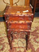 AN ORIENTAL STYLE NEST OF THREE TABLES - CARVED IN THE FAUX BAMBOO STYLE H-61 W-42 CM LARGEST