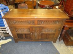 A VINTAGE CARVED OAK SIDEBOARD