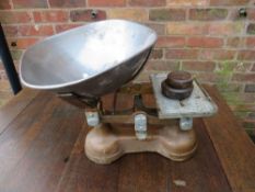 A SET OF GREEN GROCERS SCALES WITH TWO WEIGHTS