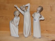 THREE LLADRO FIGURES OF CHILDREN IN GOWNS, WITHOUT MODEL NUMBERS