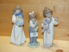 THREE NAO FIGURES OF CHILDREN WITH DOLLS AND A BEAR, ONE MARKED MODEL NUMBER 1424, THE OTHERS