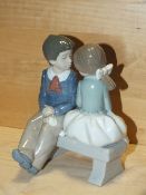 A NAO FIGURE OF A BOY AND GIRL ON A BENCH, MODEL NUMBER 1136