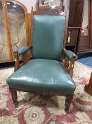 AN EDWARDIAN CARVED OAK GENTLEMANS ARMCHAIR WITH GREEN LEATHER UPHOLSTERY