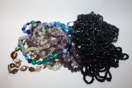 A BAG OF AMETHYST AND OTHER BEADED NECKLACES