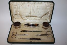 A HALLMARKED SILVER AND TORTOISE SHELL MANICURE SET