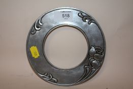 AN ART NOUVEAU PEWTER CIRCULAR PICTURE FRAME