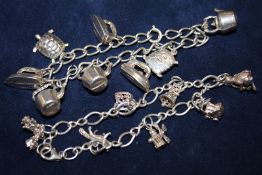 A SILVER CHARM BRACELET WITH ASSORTED CHARMS - APPROX 33.4G