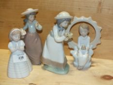 FOUR SMALL NAO FIGURES, TO INCLUDE A SEATED BOY MODEL NUMBER 1445, THE OTHERS WITHOUT MODEL NUMBER