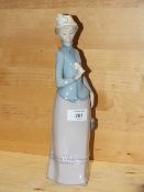 A LLADRO FIGURE OF A LADY HOLDING A FLOWER, NO MODEL NUMBER
