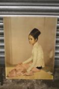 AN UNFRAMED RETRO STYLE PRINT OF A SEATED LADY