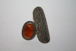 A LARGE SILVER AND MARCASITE RING TOGETHER WITH AN AMBER AND MARCASITE EXAMPLE