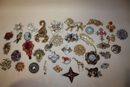 A TUB OF MOSTLY MODERN BROOCHES TO INCLUDE LARGE FLORAL EXAMPLES