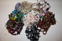 A BAG OF ASSORTED COSTUME JEWELLERY, NECKLACES ETC.