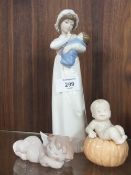 TWO SMALL NAO FIGURES OF A BOY SAT ON A PUMPKIN AND A CHERUB TOGETHER WITH NADAL FIGURE OF A WOMAN