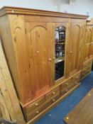 A LARGE PINE TRIPLE WARDROBE WITH CENTRAL MIRRORED DOOR AND 6 DRAWERS BELOW H-212 CMW-202 CM