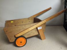 A WOODEN CHILDREN'S WHEELBARROW