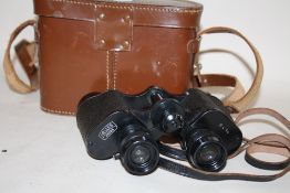 A PAIR OF LEATHER CASED HELLES OF PARIS 8X34 BINOCULARS