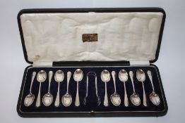 A CASED SET OF TWELVE HALLMARKED SILVER SPOONS AND SUGAR TONGS