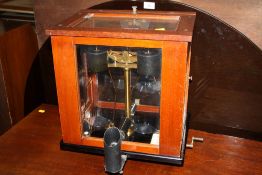 A GLASS AND MAHOGANY CASED SET SCALES BY OERTLING OF LONDON