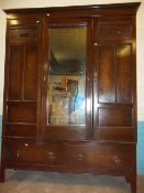 AN ANTIQUE OAK THREE DOOR MIRRORED WARDROBE