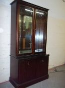 A MIRROR BACKED STAG DISPLAY WALL UNIT