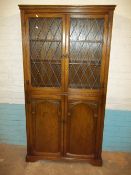 AN OAK LEADED BOOKCASE UNIT CUPBOARD