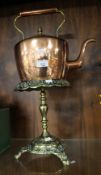 A COPPER KETTLE ON BRASS STAND