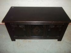 A VINTAGE DARK OAK BLANKET CHEST WITH CARVED DETAILING