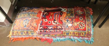 A BEDOUIN STYLE CAMEL SADDLE, 110 CM X 50 CM