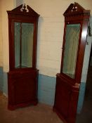 TWO MATCHING YEW LOCKING CORNER DISPLAY UNITS WITH LIGHTS AND SERPENTINE FRONT SHELF