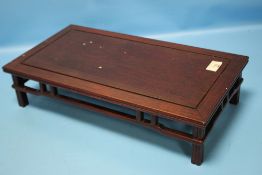 A CHINESE HARDWOOD SCHOLAR'S TABLE TOP LOW STAND RAISED ON FOUR LEGS