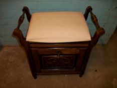 AN ANTIQUE PIANO MUSIC STORAGE STOOL