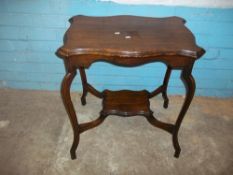 AN EDWARDIAN SIDE TABLE WITH SERPENTINE SHAPED TOP