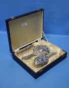 A CASED THREE PIECE HALLMARKED SILVER DRESSING TABLE SET