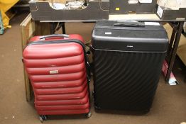 TWO MODERN SUITCASES ON WHEELS