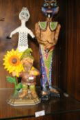 TWO PAPIER MACHE FIGURES AND A CAST IRON DOOR STOP